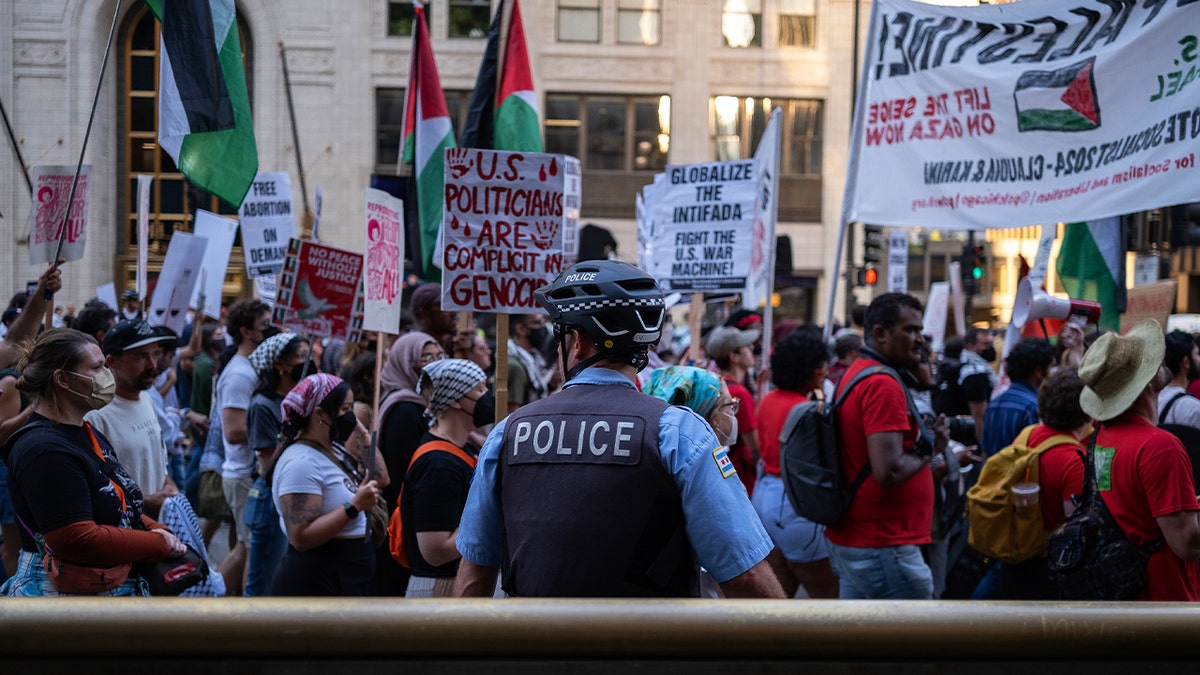 police officer watches marchers