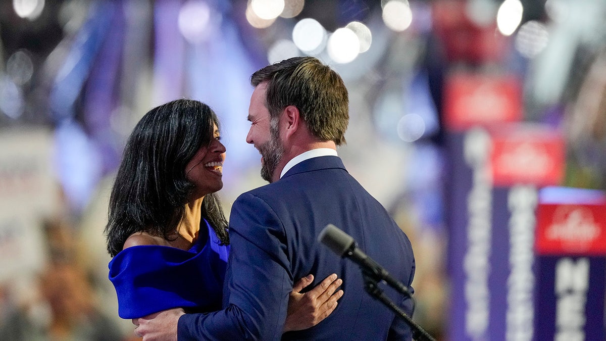 Republican vice presidential candidate Sen. JD Vance hugs his wife Usha Chilukuri Vance