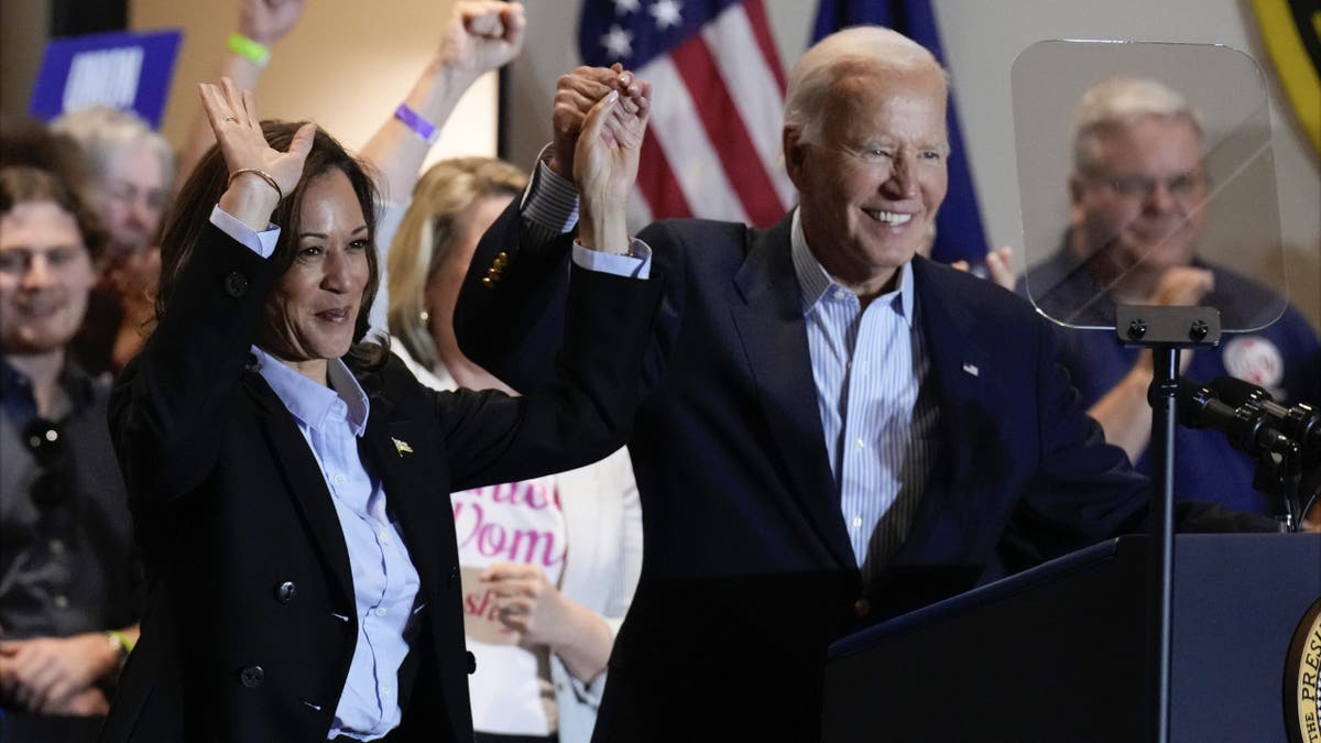 Biden and Harris raising arms at campaign event