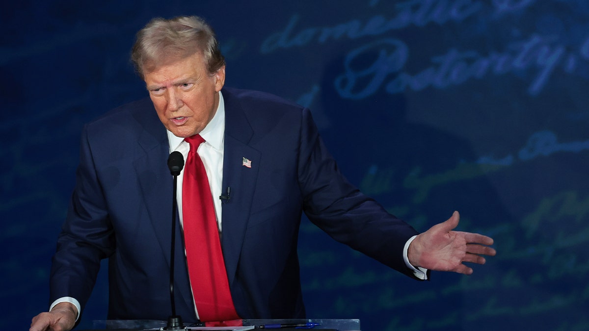 Trump debating Harris at ABC debate, closeup shot