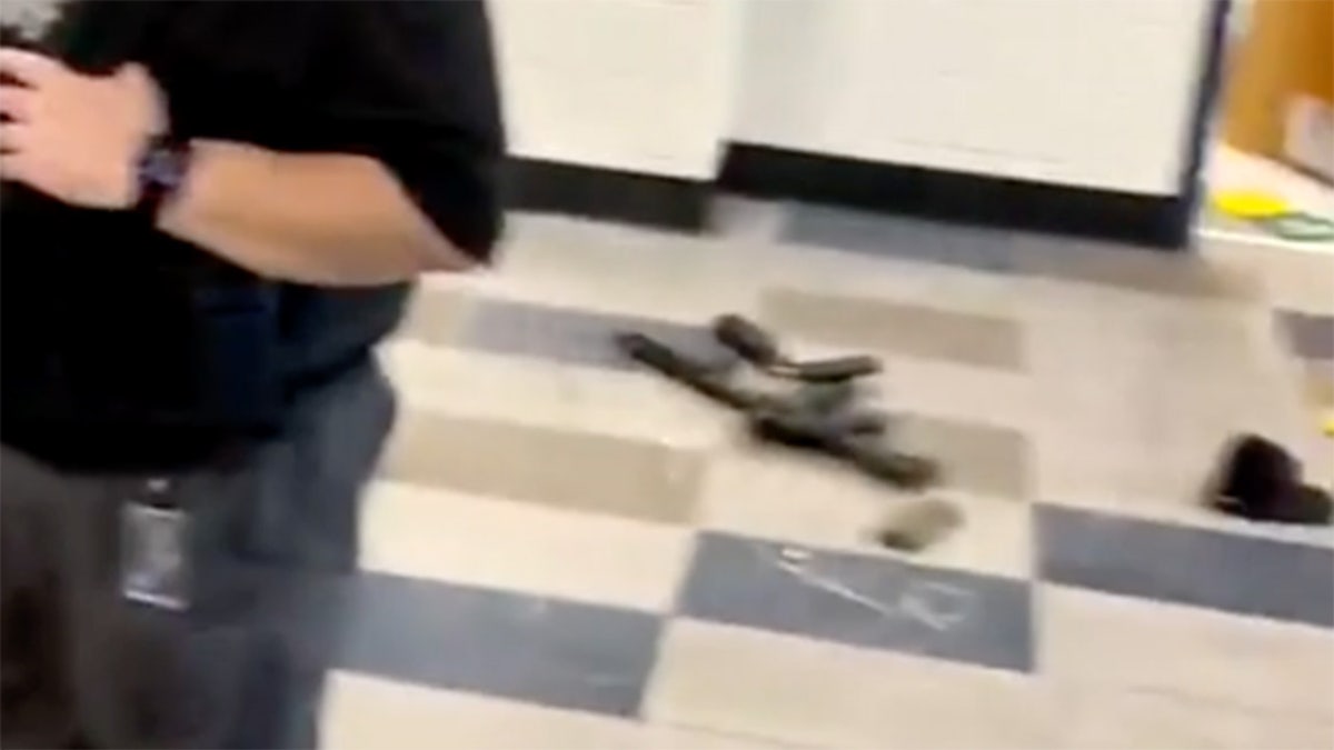 gun lying on school floor in video screenshot