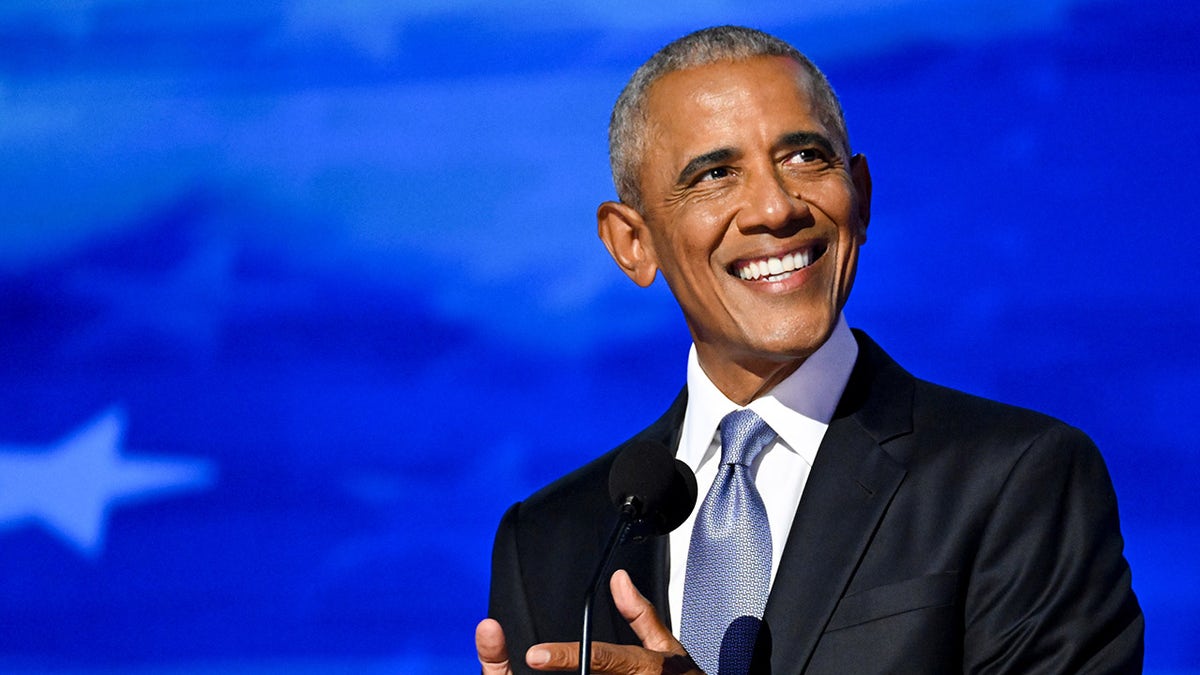 Obama smiles on DNC stage