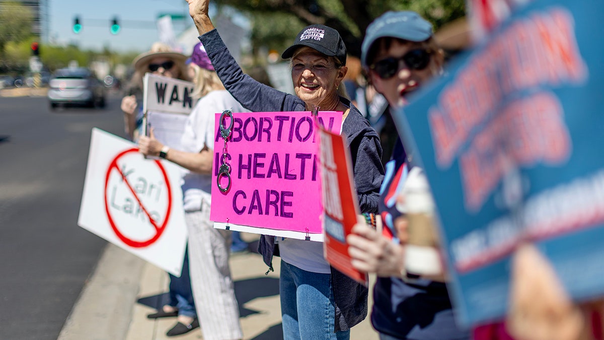 people on sidewalk with protest signs