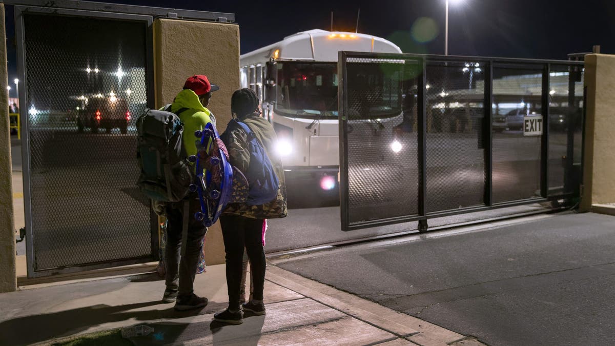 A Haitian family stands outside the U.S. Border Patrol detention facility after walking from the Mexican border through Yuma, Ariz., on Dec. 8, 2021.