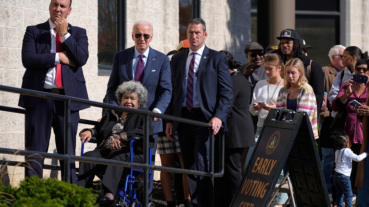 Joe Biden helping woman in wheelchair