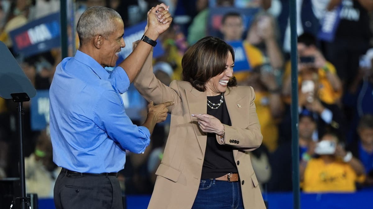 Former President Barack Obama gestures to Democratic presidential nominee Vice President Kamala Harris after introducing her to speak during a campaign rally for Harris on Thursday, Oct. 24, 2024, in Clarkston, Ga. (AP Photo/Mike Stewart)