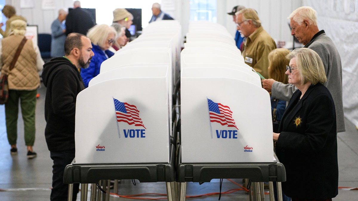 Voters make selections at their voting booths inside an early voting site on Oct. 17, 2024 in Hendersonville, North Carolina. Several counties affected by Hurricane Helene saw a large turnout of residents for the first day of early voting in western North Carolina.