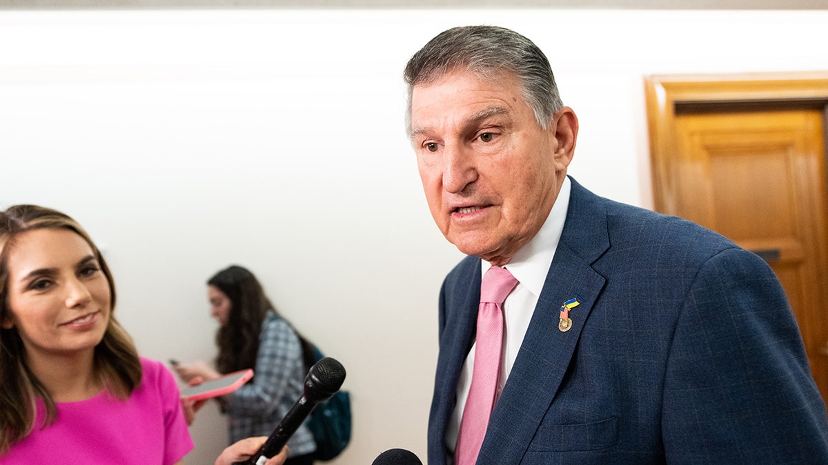 Joe Manchin talks to reporters