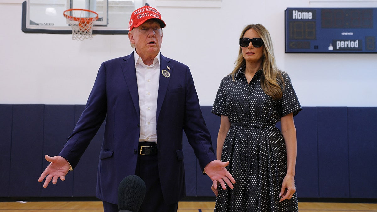 Donald Trump and Melania Trump walk after voting on Election Day