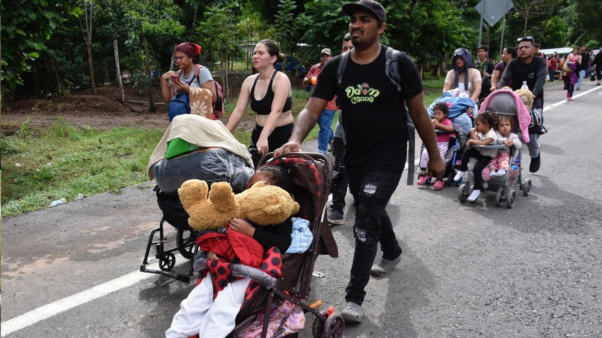 Migrants walk through Tapachula, in Mexico Wednesday.