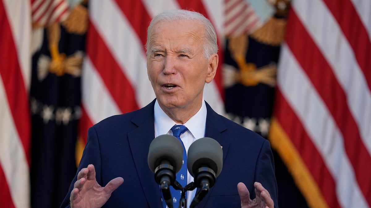 President Biden at the Rose Garden with flags behind him