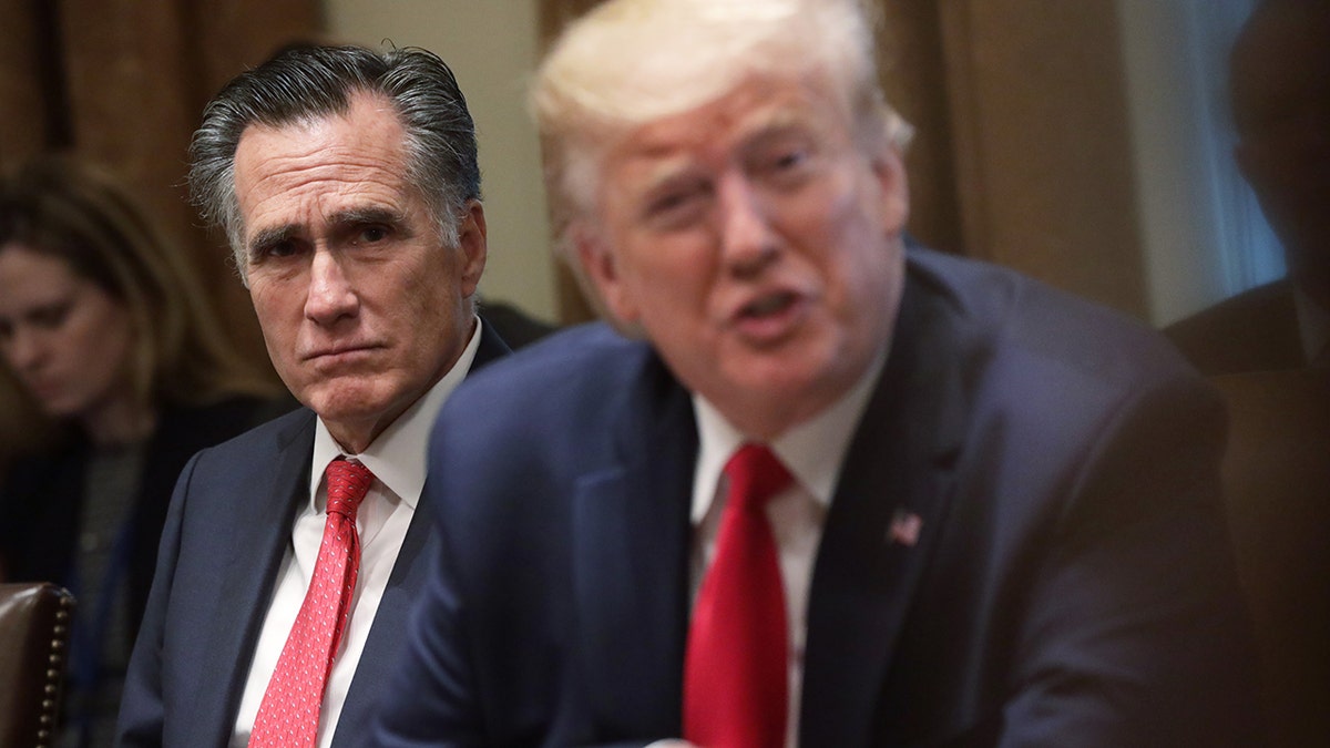 2019 file photo: Mitt Romney, left, with President Trump, right