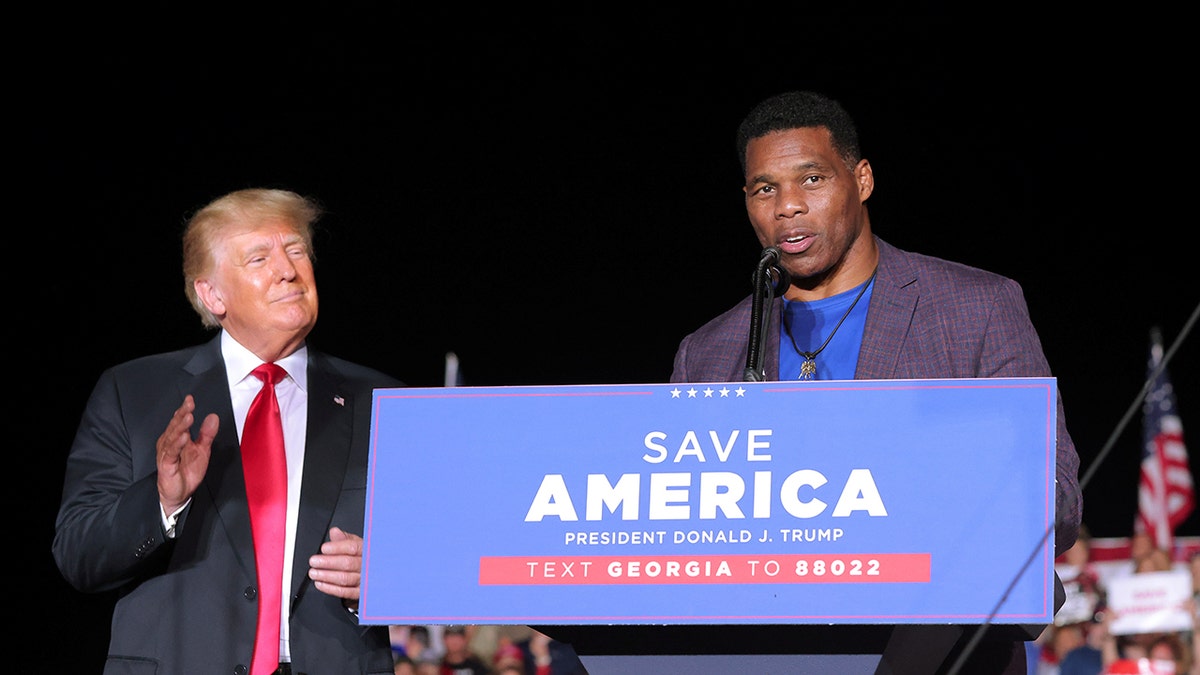 Former college football star and current senatorial candidate Herschel Walker speaks at a rally in Perry