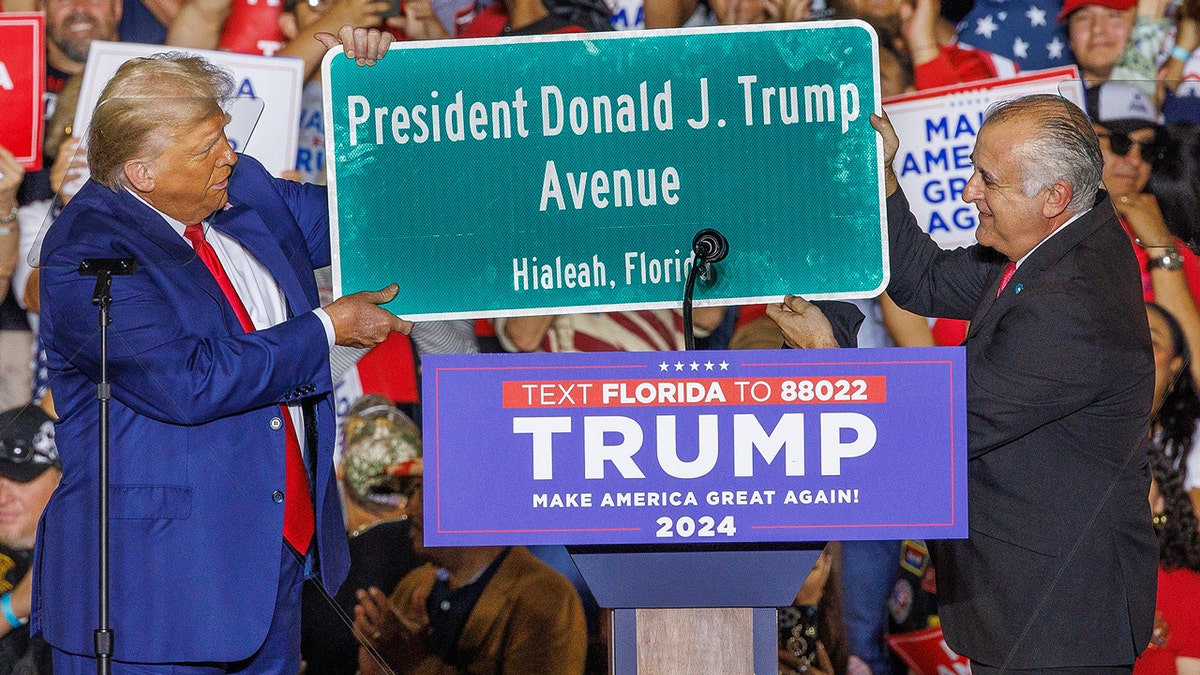 Hialeah mayor presents Trump with street sign at rally 