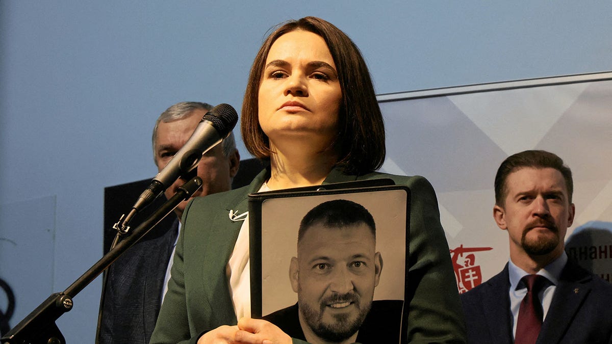 Sviatlana Tsikhanouskaya holds photo of jailed husband