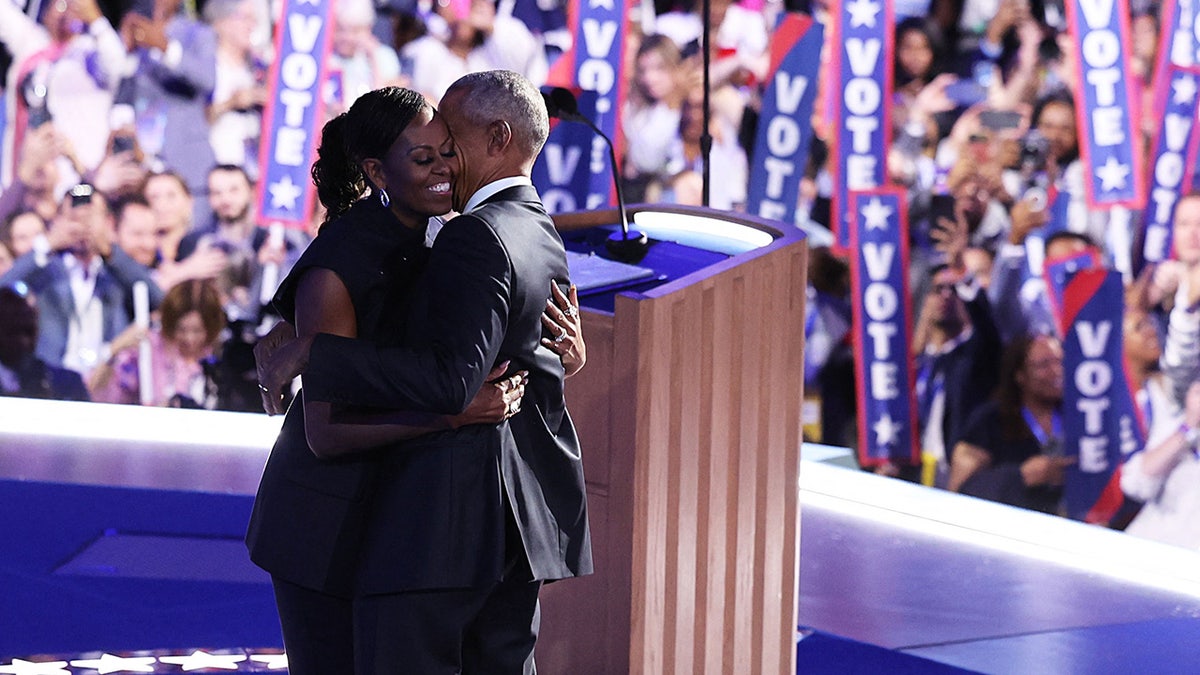 Michelle and Barack Obama embracing at 2024 DNC