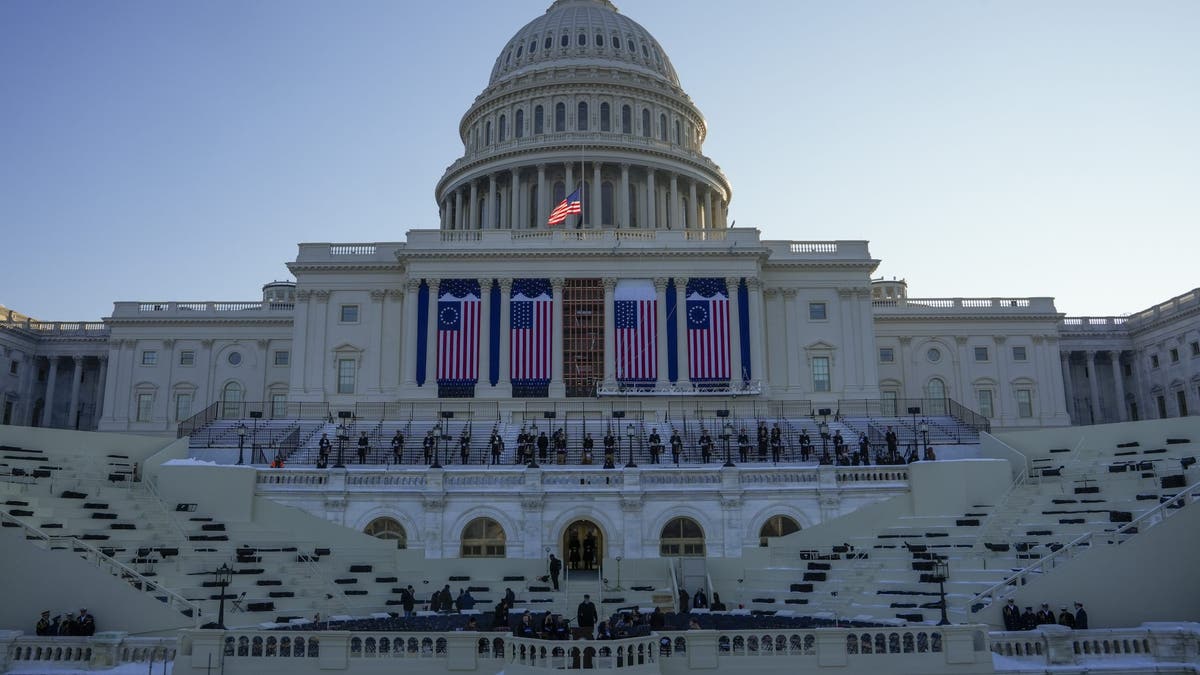 People take their places as a rehearsal begins on the West Front of the U.S. Capitol on Jan. 12, 2025, ahead of President-elect Donald Trump's upcoming inauguration. (AP Photo/Jon Elswick)