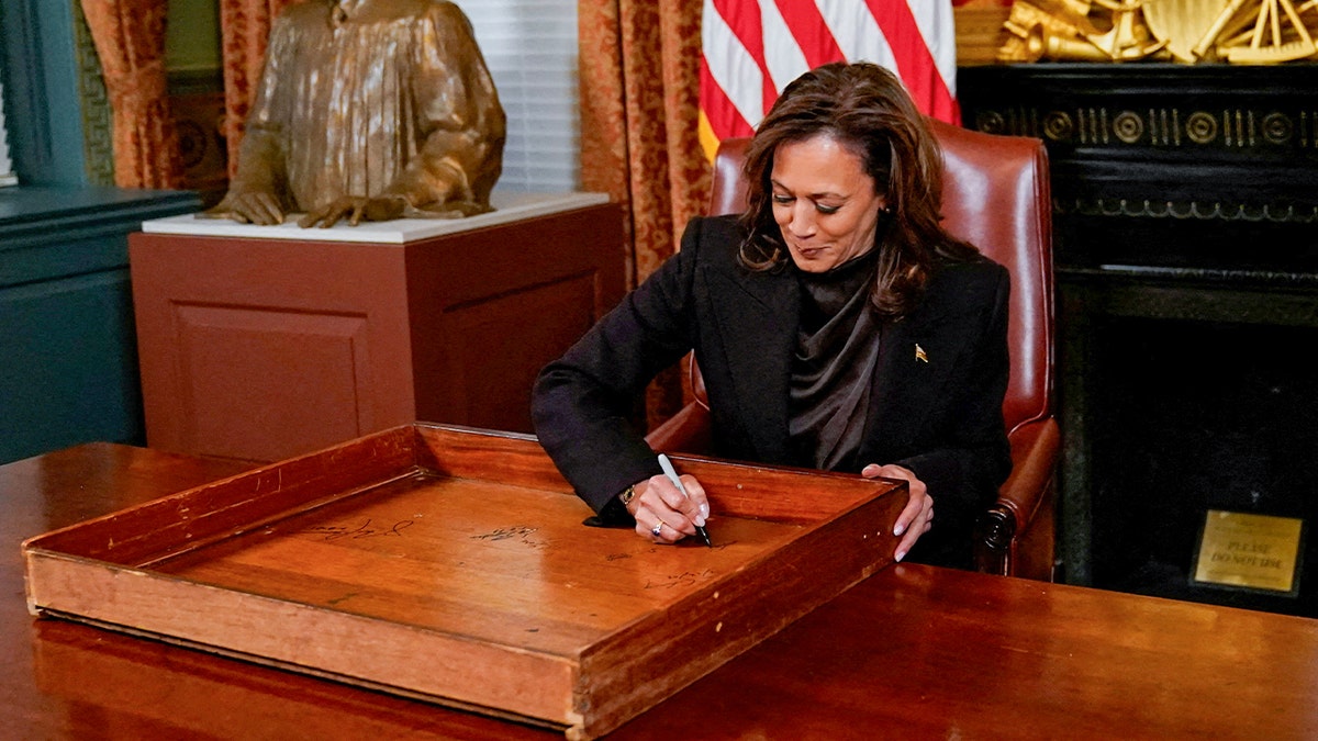 Vice President Harris signs a drawer in her ceremonial office