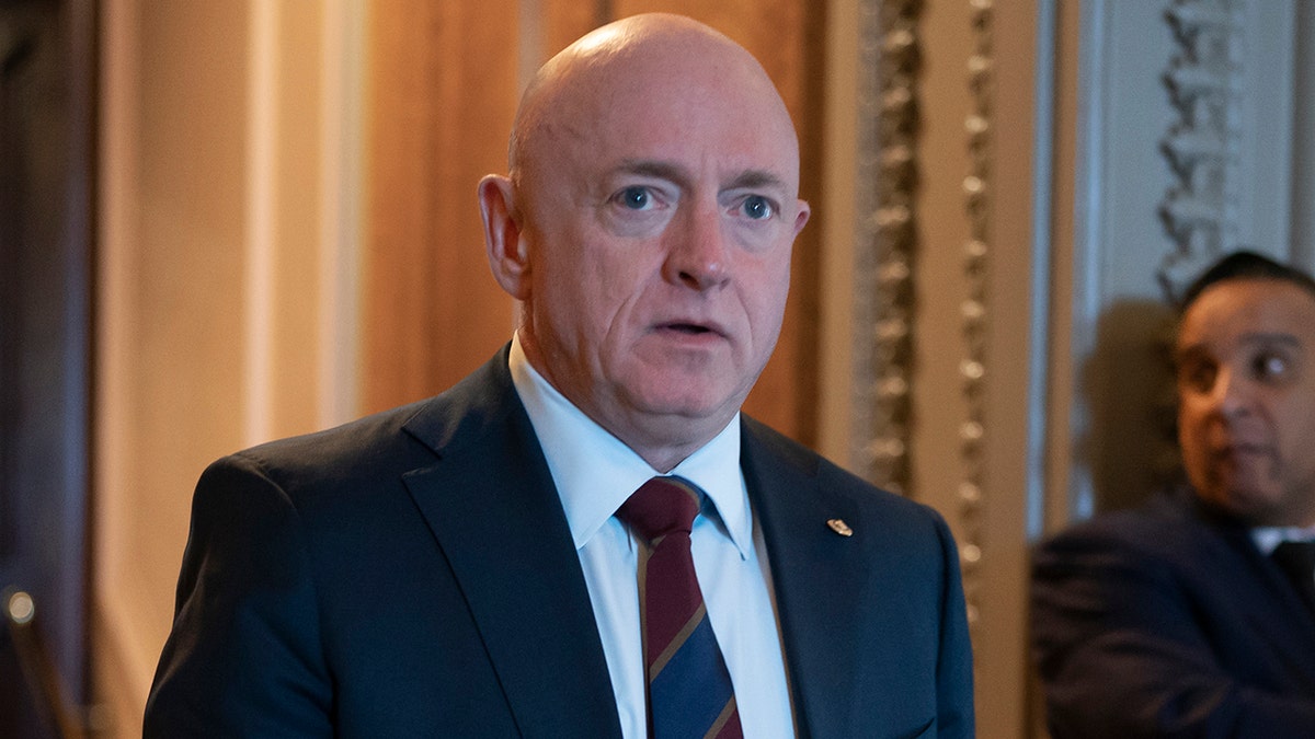 Sen. Mark Kelly, D-Ariz., leave the chamber during the vote to confirm former Los Angeles Mayor Eric Garcetti as the next ambassador to India, more than a year and a half after he was initially selected for the post, at the Capitol in Washington, Wednesday, March 15, 2023. 