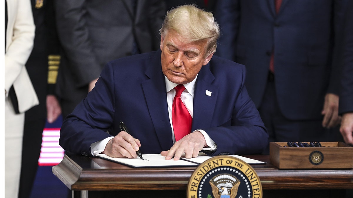 President Donald Trump signs executive order in 2020