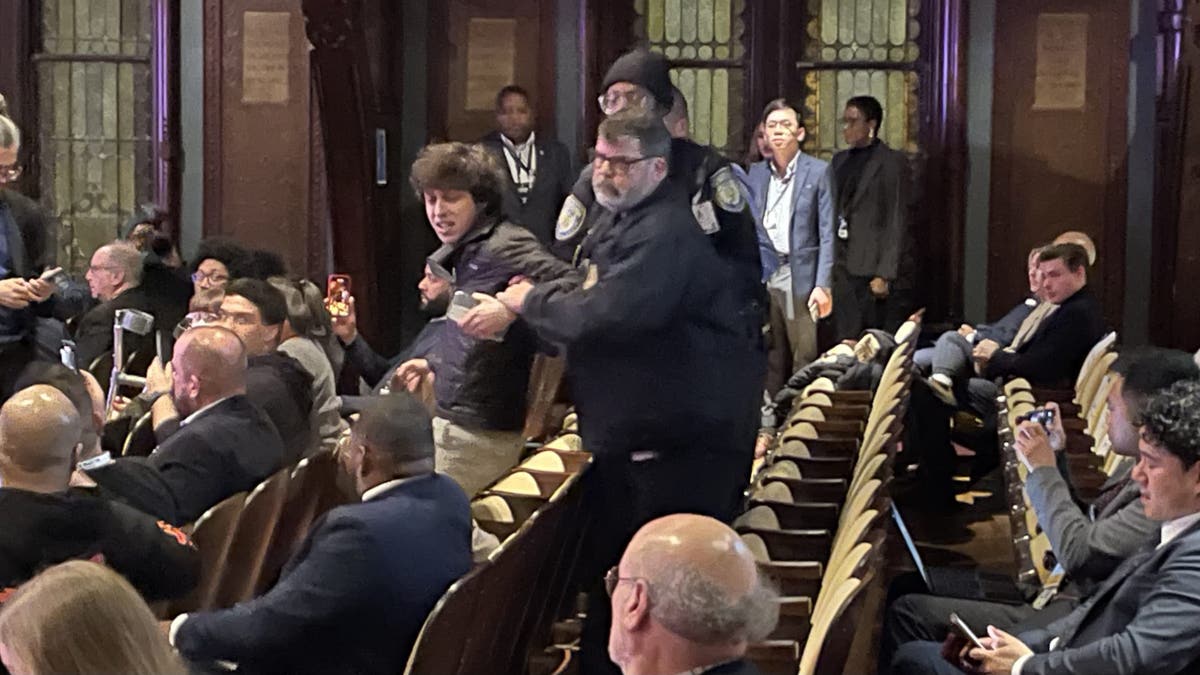 A protester is removed by security after heckling at a Democratic National Committee chair election debate at Georgetown University in Washington, D.C., Jan. 30, 2025.