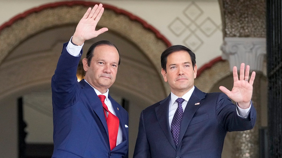 U.S. Secretary of State Marco Rubio, right, waves after being welcomed by Panama's Foreign Minister Javier Martinez-Acha