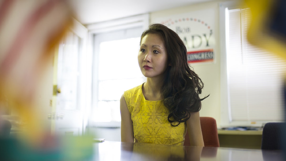 lindy li behind desk