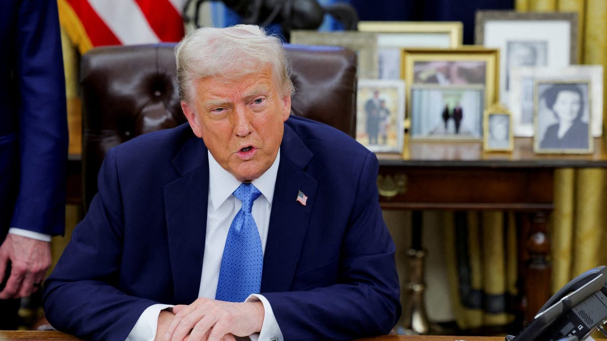 Trump speaks to reporters at the White House while signing executive orders 