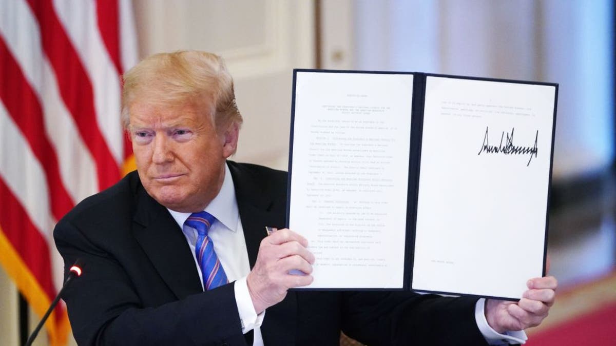 President Donald Trump holds an executive order on "Continuing the President's National Council for the American Worker and the American Workforce Policy Advisory Board," which he signed during an American Workforce Policy Advisory Board meeting in the East Room of the White House in Washington, D.C., on June 26, 2020.