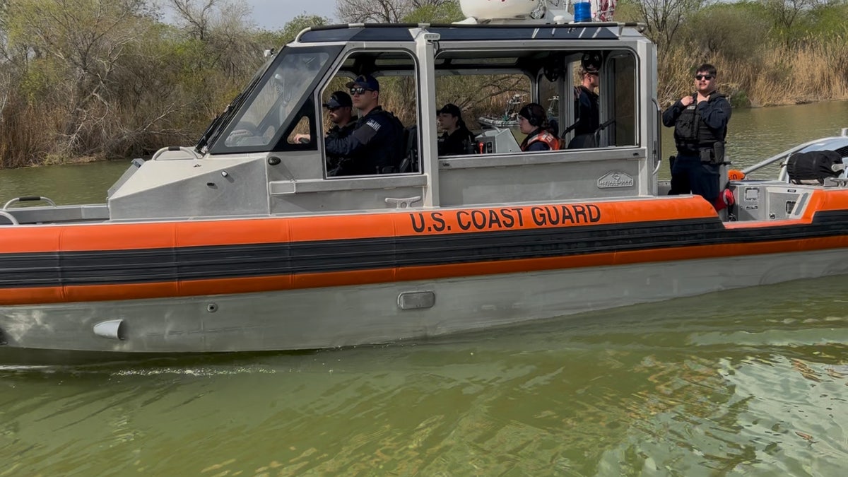 U.S. Coast Guard Boat filled with crew members patrols the Rio Grande