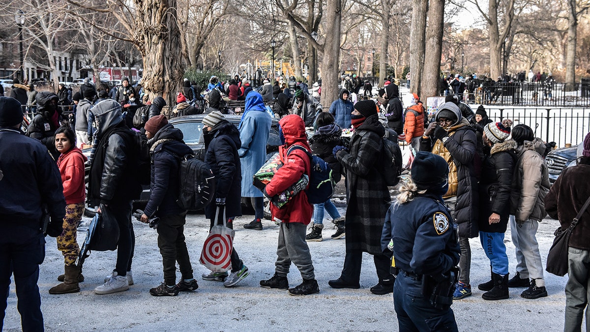 Migrants in New York City crowd around for free food