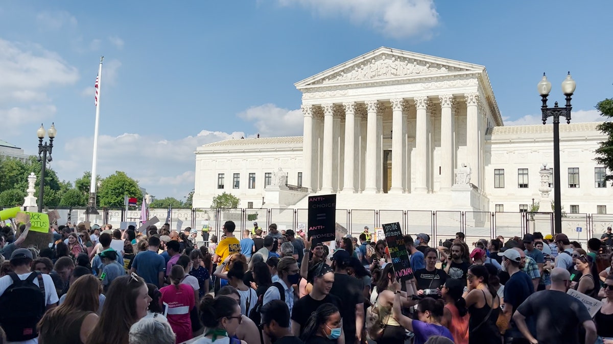 Protesters gather outside the Supreme Court building