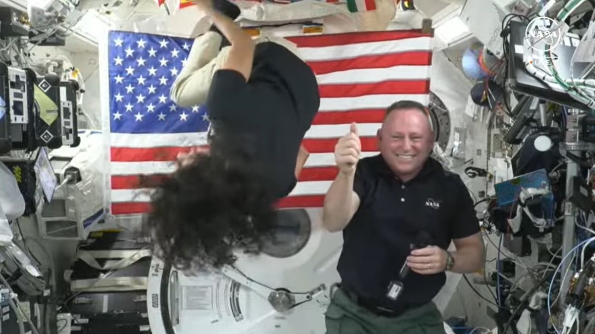 Astronaut Suni Williams does a backflip as Butch Wilmore gives a thumbs up while in space.