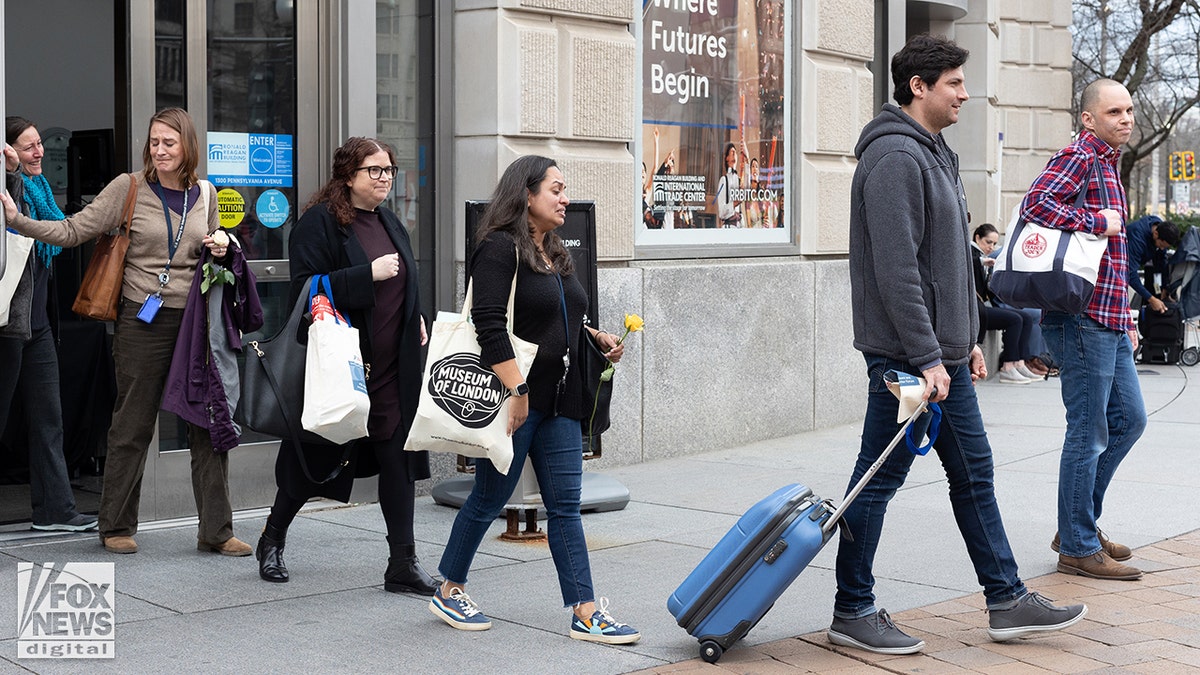 USAID workers leave HQ in DC after being laid off on the advice of DOGE