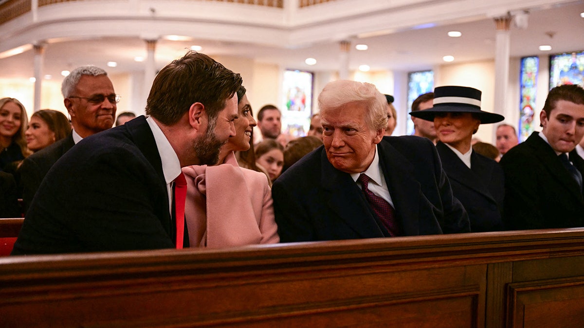 US President-elect Donald Trump speaks with Vice President-elect JD Vance during a church service at St. John's Episcopal Church