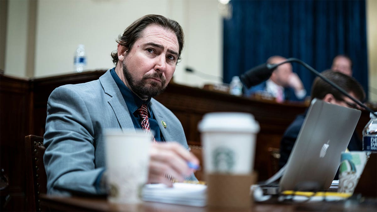 Rep. Eli Crane sitting down with a Starbucks cup nearby