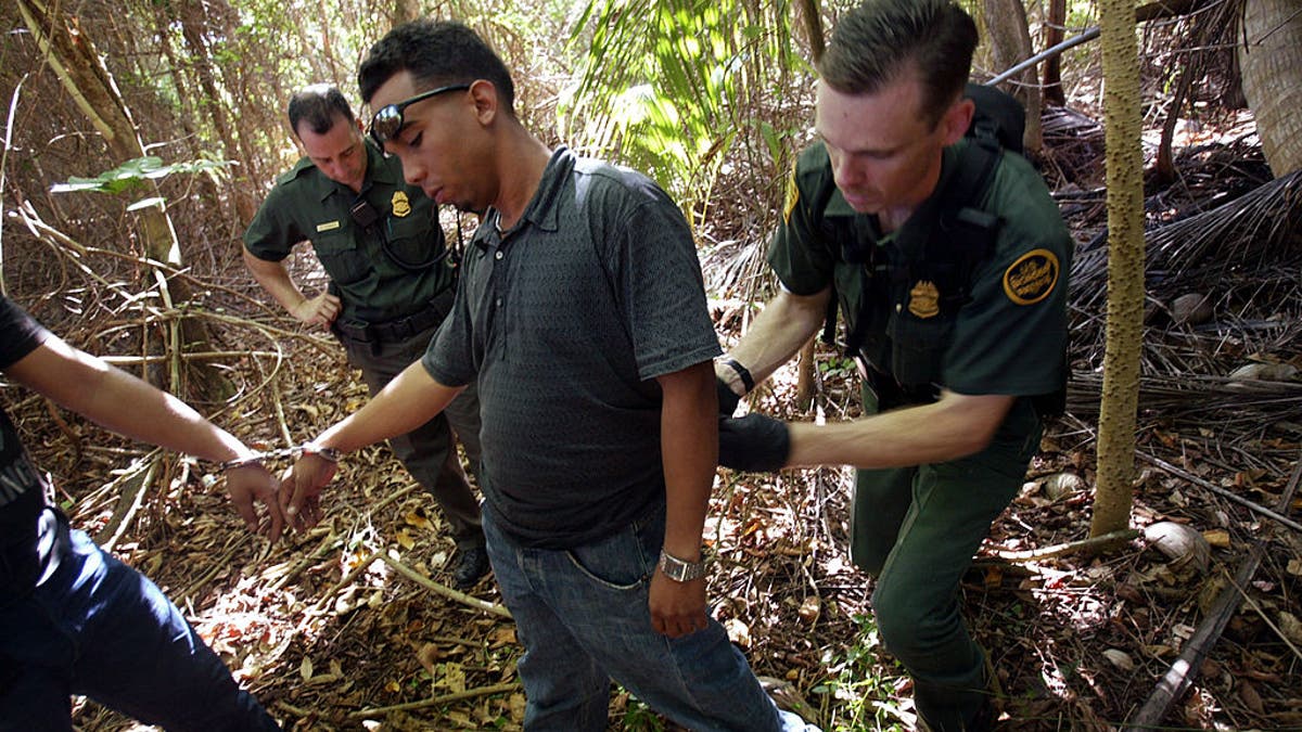 migrant being arrested