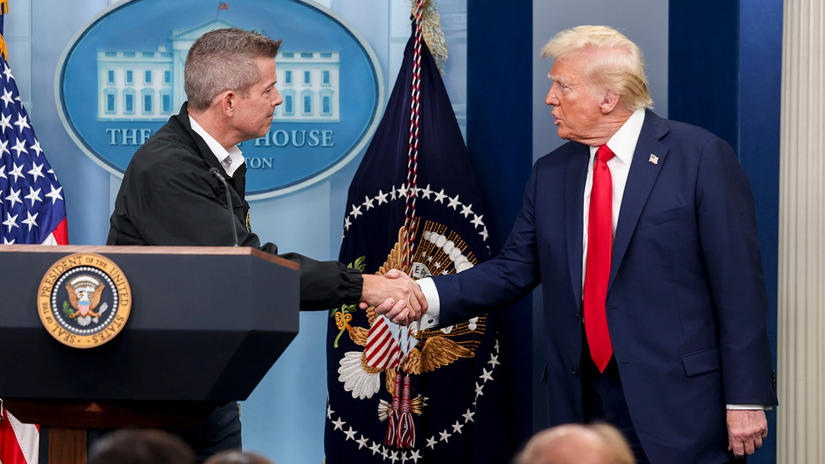 Duffy and President Donald Trump shake hands