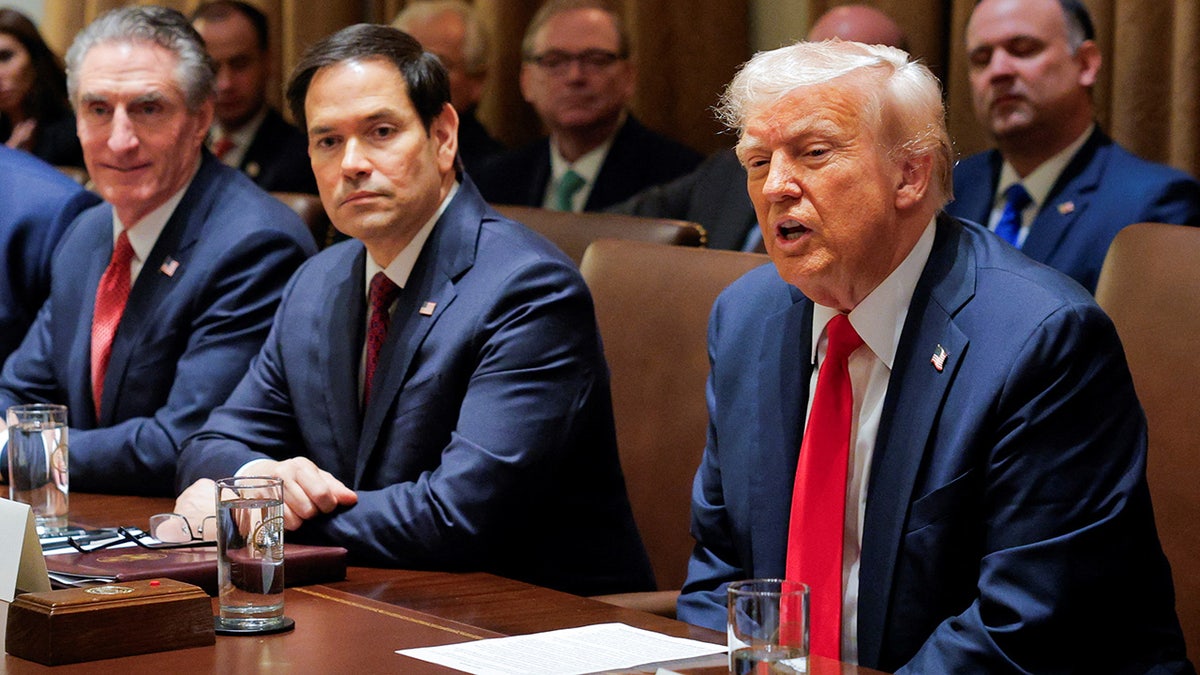 President Donald Trump hosts his first cabinet meeting as he sits next to Secretary of State Marco Rubio