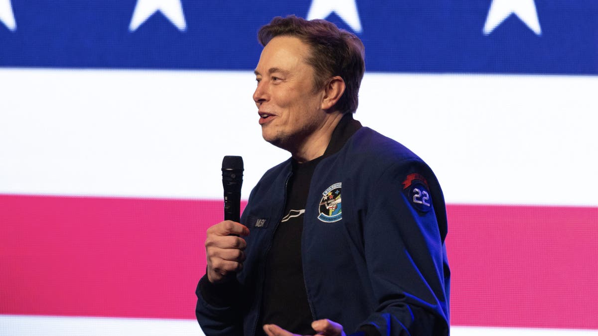 Elon Musk closeup shot, holding microphone