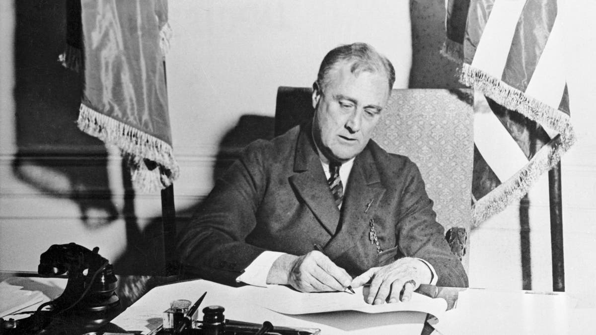 FDR black and white photo signing document