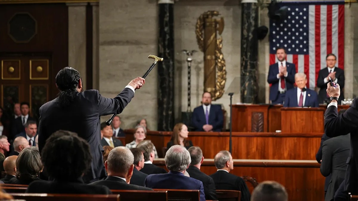 Rep. Al Green seen from behind scolding President Trump at speech