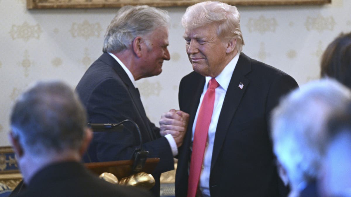 President Donald Trump greets Rev. Franklin Graham during an Easter prayer service and dinner in the Blue Room of the White House in Washington, Wednesday, April 16, 2025. (Pool via AP)