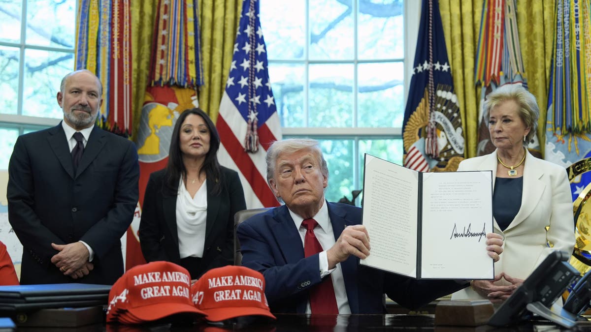 Trump signing executive orders in the Oval Office