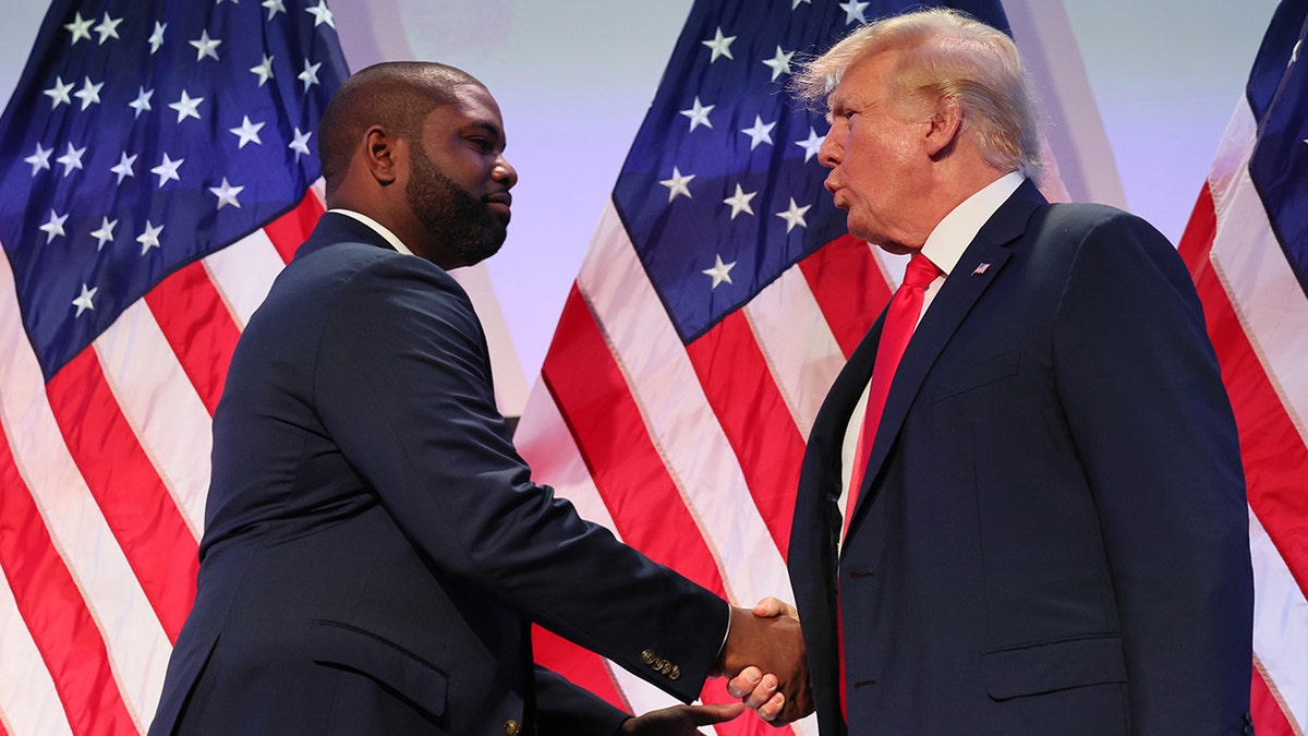 Rep. Byron Donalds and former President Donald Trump shake hands in 2023