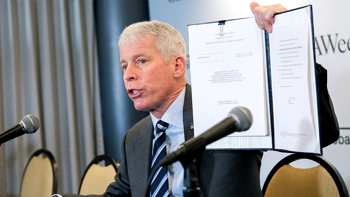Chris Wright, US secretary of energy, displays a signed order approving an LNG permit extension for the Delfin LNG project on the Louisiana Coast: F. Carter Smith/Bloomberg via Getty Images