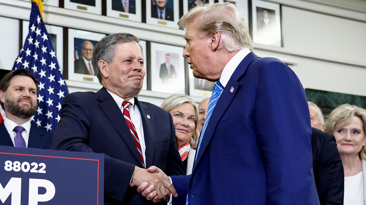Sen. Steve Daines shakes hands with then-former President Donald Trump in 2024