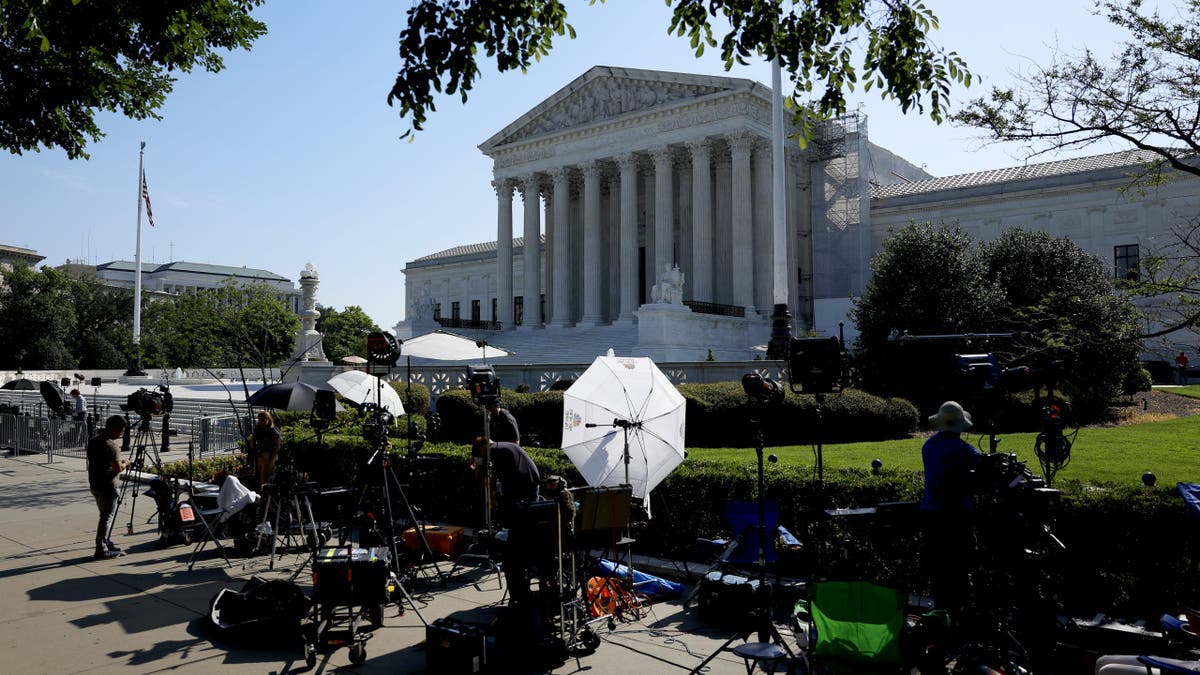 Journalists work outside of the U.S. Supreme Court Building in Washington, DC. (Photo by Anna Moneymaker/Getty Images)