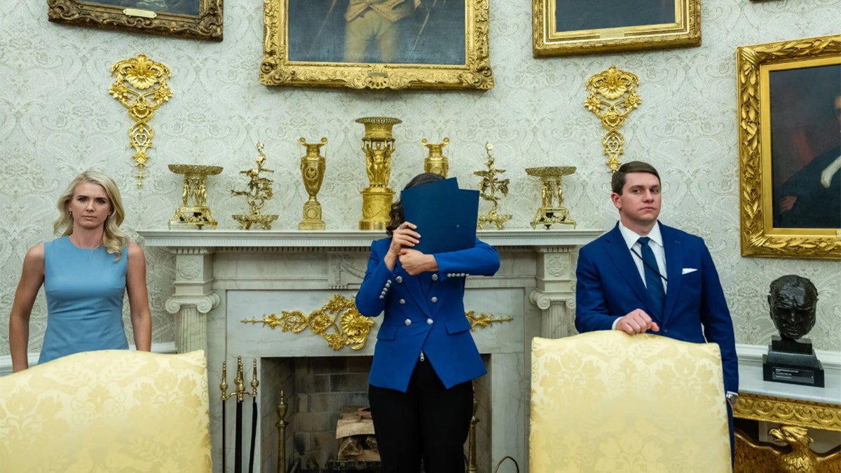 Michigan Gov. Gretchen Whitmer covers face in Oval Office