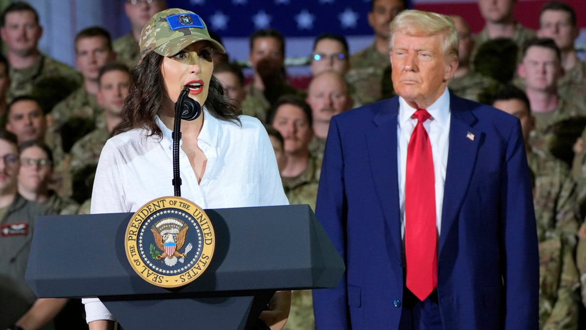 President Donald Trump listens as Michigan Gov. Gretchen Whitmer speaks to members of the Michigan National Guard at Selfridge Air National Guard Base, Tuesday, in Harrison Township, Mich.